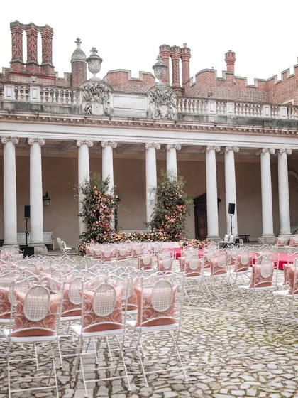 The full ceremony setup in the palace courtyard, ready for guests to arrive. The scale and symmetry of the arrangement create a powerful visual impact.
