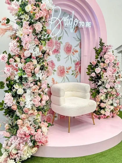 Celebrating the bride-to-be should be as beautiful as she is. This dreamy floral setup, with its cascading pink roses, elegant arch, and statement chair, creates a perfect, Instagram-worthy backdrop for a bridal shower or mehendi ceremony.