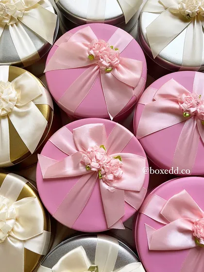Beautifully decorated pink and gold tins for a Women's Day order. The intricate ribbon work and floral details make these a stunning gift option.