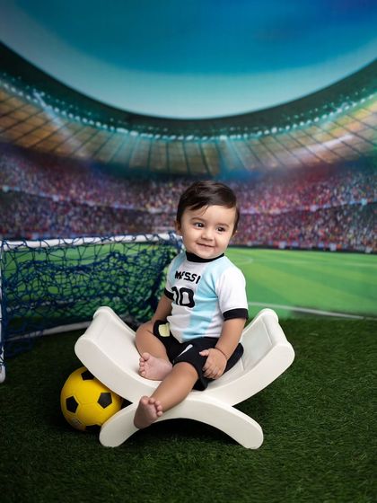 A happy little Messi fan enjoying his football-themed sitter session.