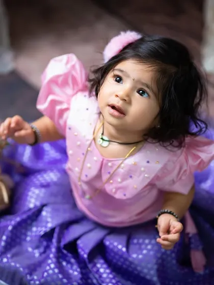 Looking up with wonder. The soft lighting and beautiful colors make this a truly enchanting portrait.