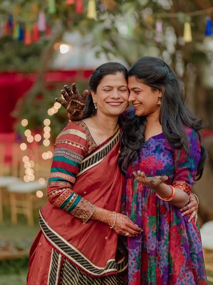 A heartwarming hug between sisters at a mehendi ceremony. These events are about celebrating the bonds of family before the big day.