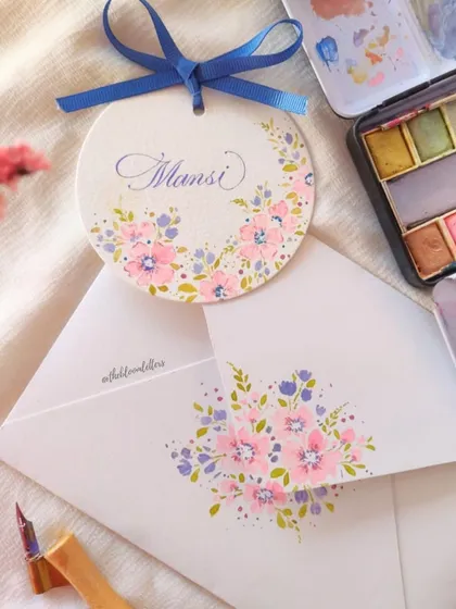 A personalized, hand-painted name tag and a matching envelope, demonstrating my signature floral style on a smaller scale.