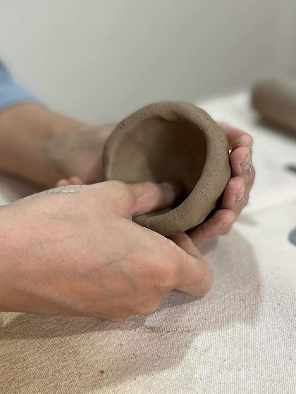 A simple pinch pot is a great starting point for any beginner. It's a meditative process of slowly shaping the clay with your fingers.