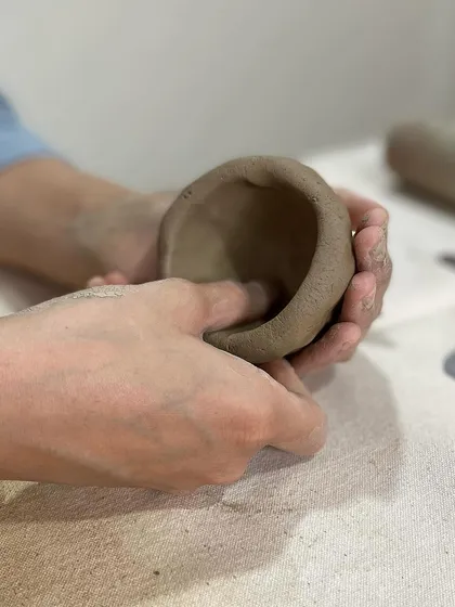 A simple pinch pot is a great starting point for any beginner. It's a meditative process of slowly shaping the clay with your fingers.