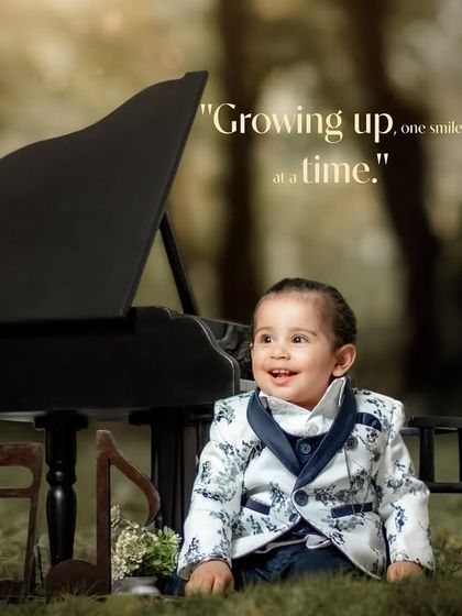 Growing up one smile at a time. A dapper young gentleman in a floral print suit jacket sits by his piano outdoors.