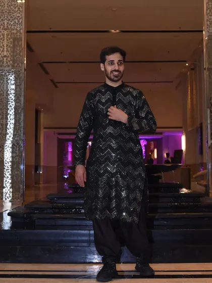 The full look for the brother of the bride. The modern, tailored kurta paired with stylish shoes creates a contemporary ethnic look perfect for a sangeet or cocktail party.