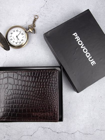The dark brown crocodile wallet presented in its branded gift box.