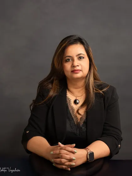 A classic, powerful headshot. The dark blazer and direct gaze convey confidence and expertise, making this a strong choice for a corporate leader or entrepreneur.