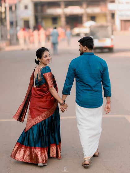 A candid "follow me" shot on a city street. The vibrant colors of her traditional half saree look stunning in the urban environment.