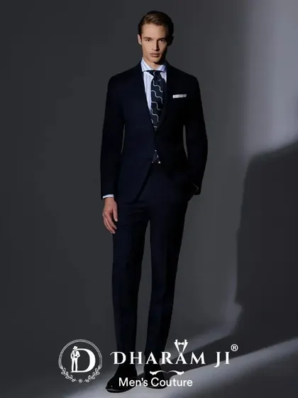 A classic navy blue suit, perfectly tailored. This is a wardrobe essential for any man, versatile enough for business meetings or formal events.
