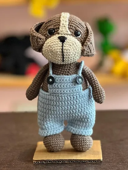 This dapper doggo in his little blue overalls is one of our newest amigurumi characters. The details, like the tiny buttons, are all carefully stitched by hand.
