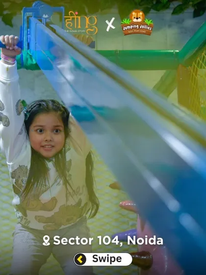 A young girl navigates the zipline, a thrilling feature in our play area. It offers a safe, exciting ride from one end of the structure to the other.