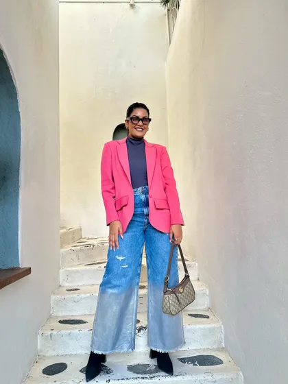 A full-length shot of my pink blazer outfit. Creating balanced looks with different textures, like the metallic sheen on the jeans and the soft wool of the blazer, is something I enjoy.