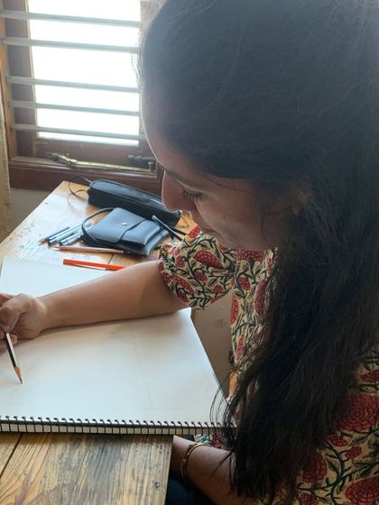 A student smiles as she sketches, finding joy in the process of learning and creating. This is what our Gurukul is all about.