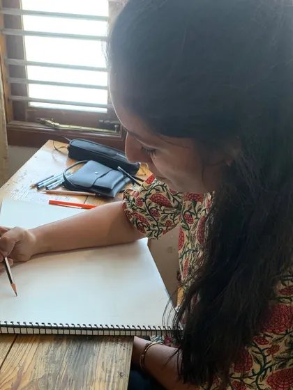 A student smiles as she sketches, finding joy in the process of learning and creating. This is what our Gurukul is all about.