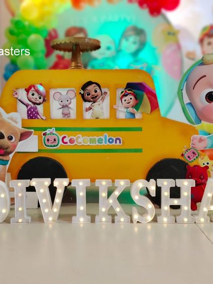 Personalization is key. We created custom light-up letters for the birthday girl's name, placed right in front of the Cocomelon bus prop for a perfect photo opportunity.