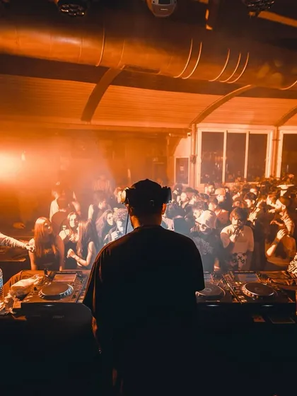 A view from behind the decks at a club, looking out at a full dance floor. This is the perspective from which I read the room and guide the night.
