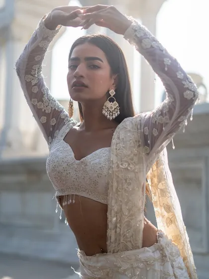 Another piece from our Ivory Edit. This elegant look features a full-sleeve sheer blouse with delicate white embroidery, perfect for a chic and modern bride or guest.