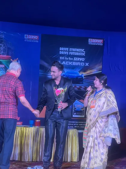 Being felicitated on stage at a corporate event for Servo Lubricants in Delhi.