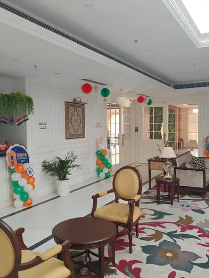 This view of the hotel lobby shows the full effect of the Republic Day decorations, from the reception desk to the seating area, all tied together with tricolor elements.