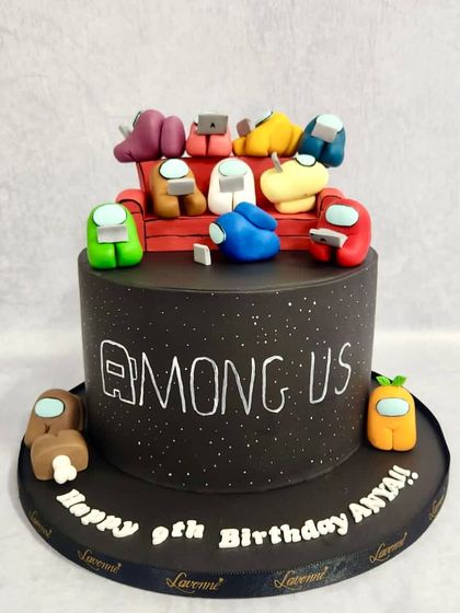 An "Among Us" cake for a 9th birthday party. We recreated the iconic characters hanging out on the couch, all made from fondant. It was fun figuring out who the imposter was!
