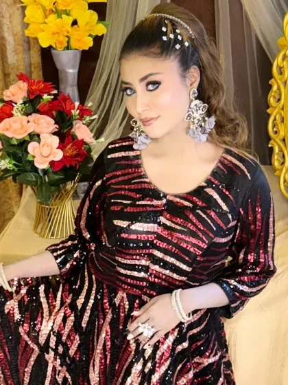Another look from the same shoot, with a focus on the bold eye makeup and statement earrings.