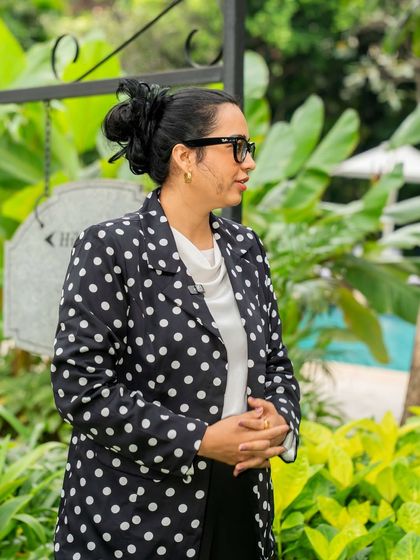 A side profile shot while I'm focused on the event proceedings. The polka dot blazer adds a touch of personality to a formal corporate look.