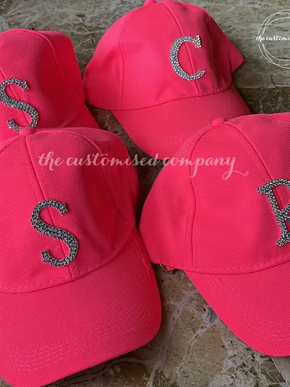 Thinking pink? These neon pink baseball caps with rhinestone initials are perfect for a Barbie-themed party or for anyone who loves a pop of color.