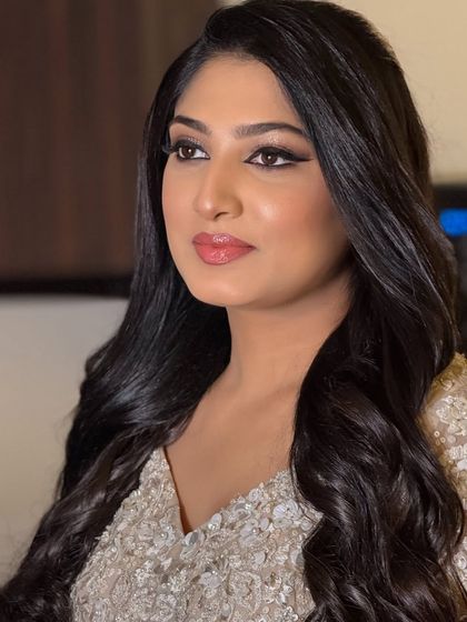 A beautiful reception look for this client. The makeup is glamorous with a classic winged liner and soft waves, perfect for an evening celebration.