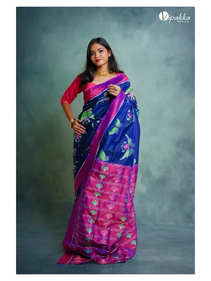 A similar pose from the same shoot, showing the saree's vibrant colors and patterns. This is a standard and effective shot for any saree catalog.