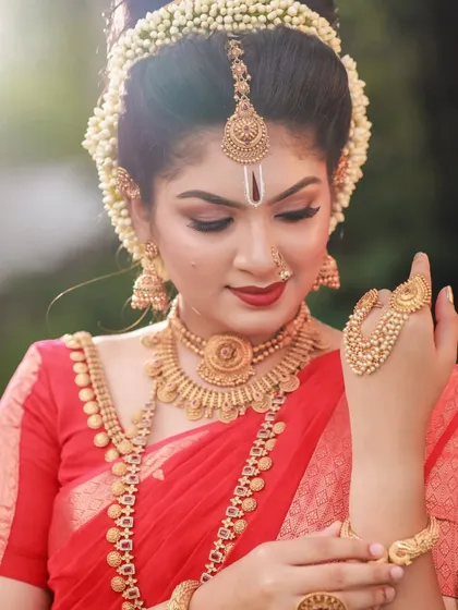 This shot focuses on the intricate details of the bride's hand jewelry (hathphool) and the rich texture of her red saree. It's a celebration of traditional adornments.