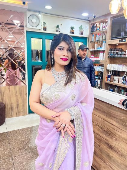 A beautiful shot of the client at our salon reception, showcasing her complete look.