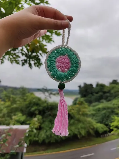 This mini dreamcatcher is perfect for smaller spaces or even as a car accessory. The pink and green colors give it a soft, calming vibe, ready to catch all your good dreams.