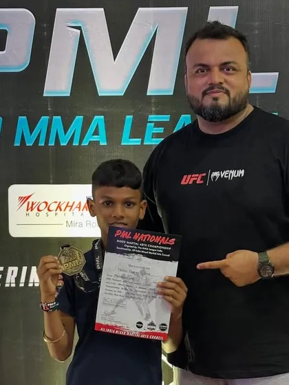 Me with Ansh Gupta, one of our under-12 gold medalists at the PML National MMA Championship. I personally guide each fighter, helping them turn their potential into knockout performances.