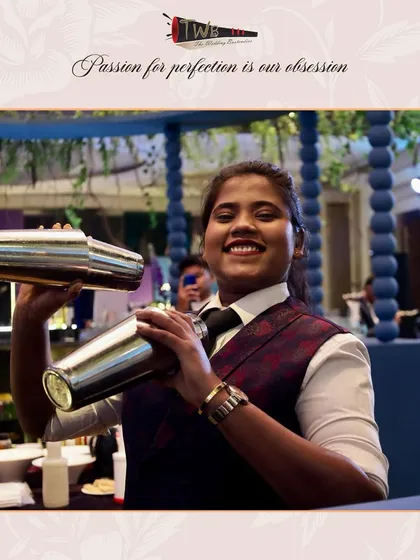 Our female bartender shaking up two cocktails at once, showcasing her skill and efficiency during a busy Sangeet night.