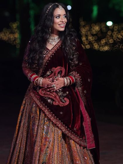 Another shot of Palak's beautiful reception or wedding look. The deep velvet shawl and soft makeup create a look of pure elegance.