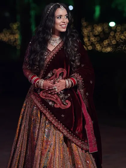 Palak's reception look was all about subtle elegance. Her multi-colored lehenga was paired with a soft makeup look and beautiful open waves.