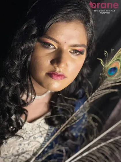 The hairstyle for this Haldi look is designed to be both beautiful and practical, keeping the hair away from the face while still looking elegant. This is part of our comprehensive event styling training.