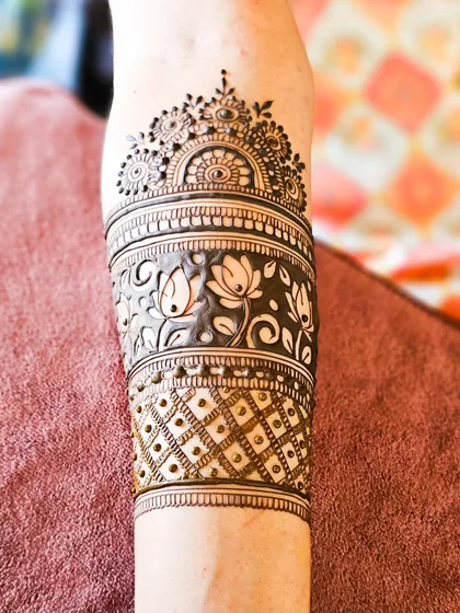 A close-up of the armband, featuring a beautiful band of lotus flowers.