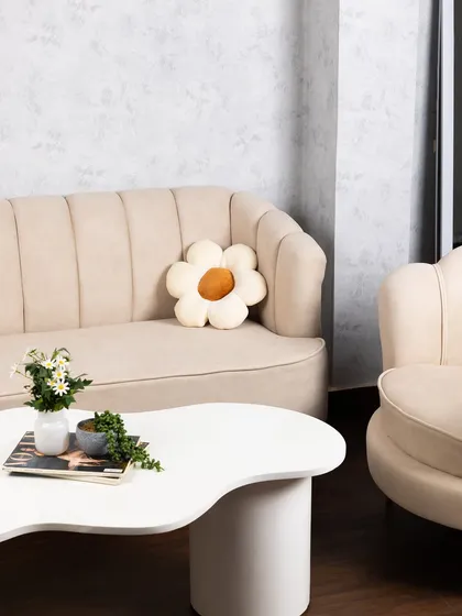 Our lounge area features a beautiful beige fluted sofa and a unique coffee table, creating a chic, ready-to-shoot corner for lifestyle content or client meetings.
