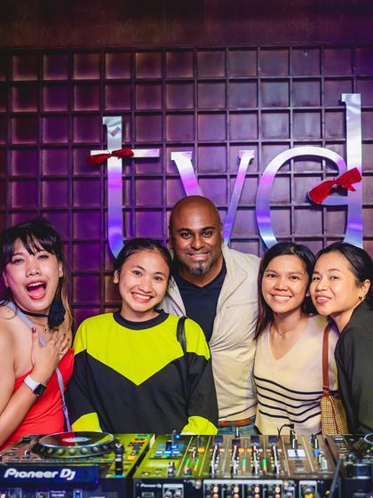 A group photo with fans at the DJ booth.