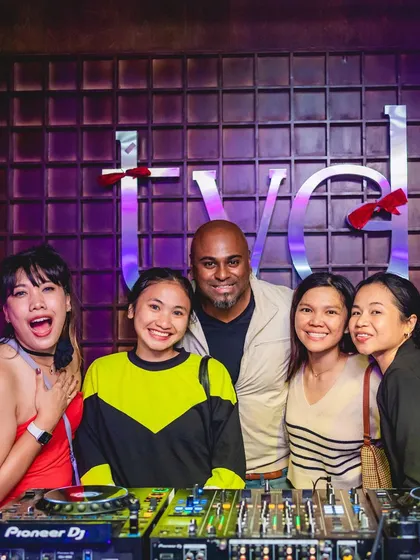 A group photo with fans at the DJ booth.