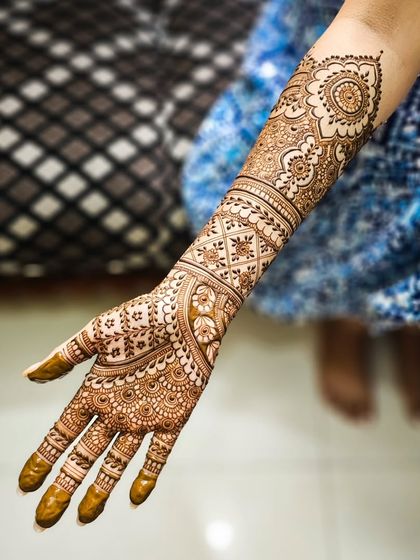 A single arm shot of a beautiful bridal design, featuring a mix of mandalas and traditional band work.