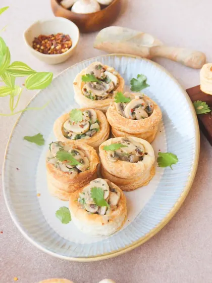 Mushroom Vol Au Vent, a classic French appetizer. Flaky puff pastry cases are filled with a creamy, garlicky mushroom sauce.