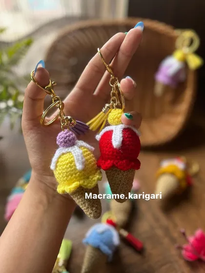 A pair of our handmade ice cream cone keychains, one in yellow and one in red. They are a fun, summery accessory and make for a great gift.