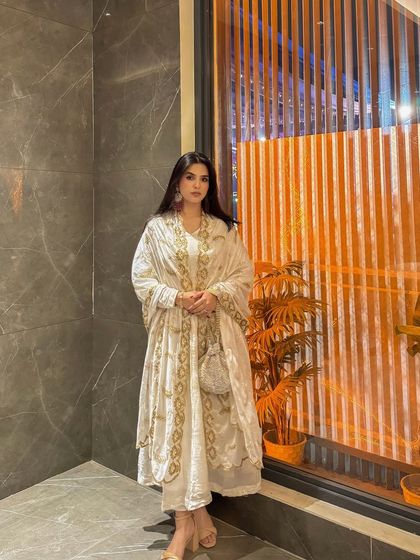 A poised, elegant stance in the white and gold Anarkali, perfect for a brand's lookbook or social media feed.