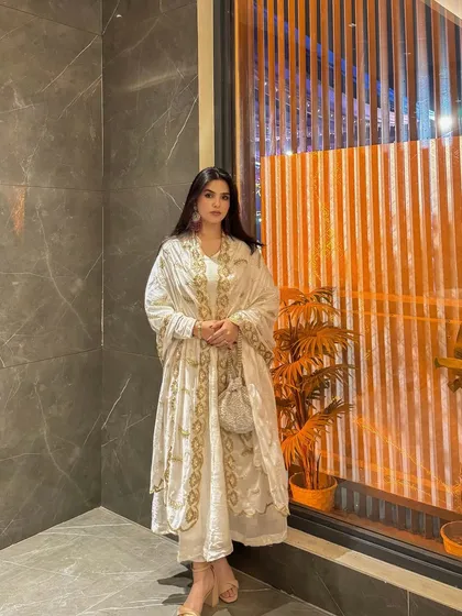 A poised, elegant stance in the white and gold Anarkali, perfect for a brand's lookbook or social media feed.