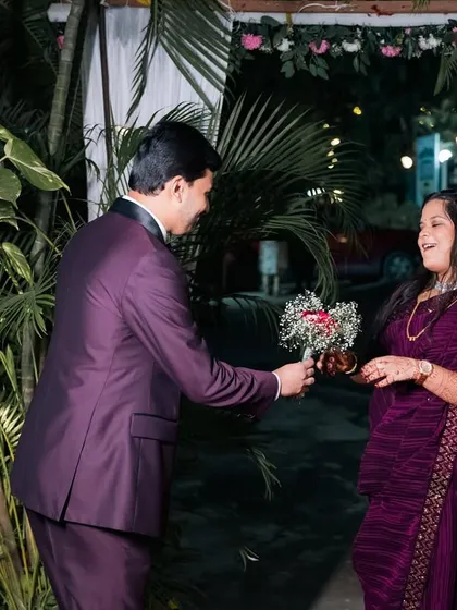 The bride's happy reaction to receiving a surprise bouquet from her groom.