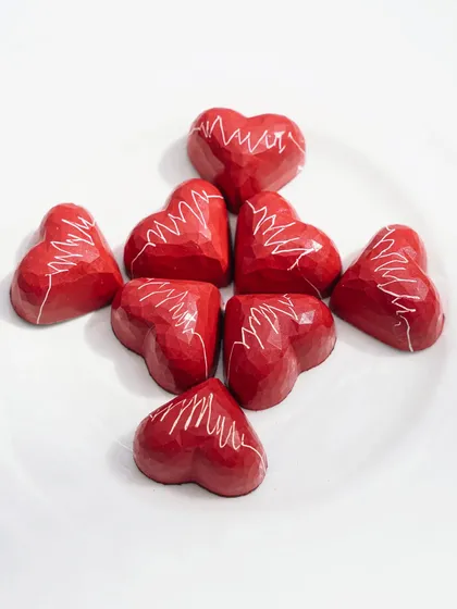 Heart-shaped chocolates for a Valentine's Day project. The clean, bright, high-key lighting and simple composition put all the focus on the intricate design of the chocolates.